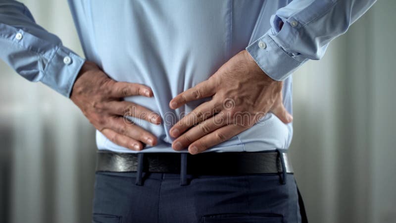 Business person feeling lower back pain, nerves inflammation, kidneys disorder, stock photo. Business person feeling lower back pain, nerves inflammation, kidneys disorder, stock photo