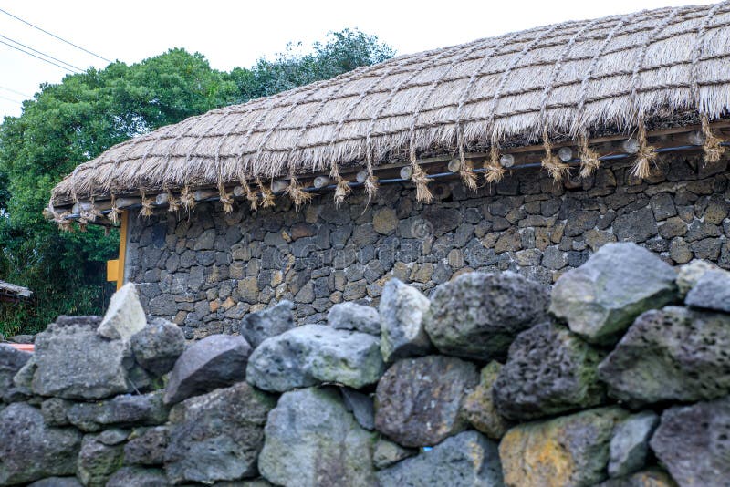 The house of traditional style for the garage with blue sky background at Seongeup Folk Village, Jeju island, South Korea. The house of traditional style for the garage with blue sky background at Seongeup Folk Village, Jeju island, South Korea