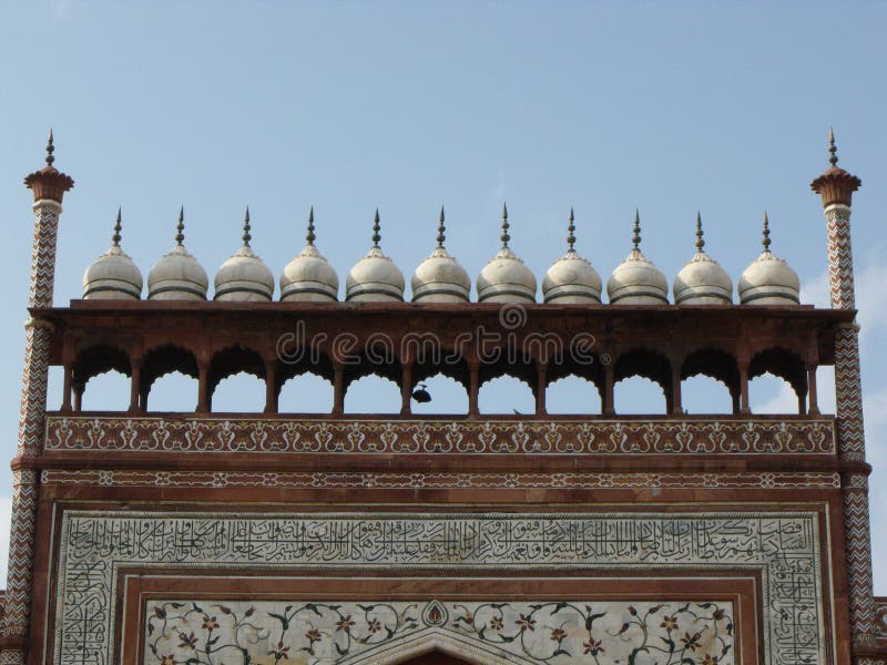 Dome and decoration with Arabic letters at the entrance to the Taj Mahal compound