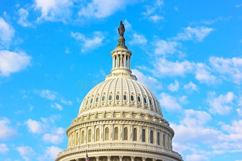 The dome of US Capitol building in Washington DC. Statue of Freedom at the top of US Capitol under a blue sky with clouds stock photography The dome of US Capitol building in Washington DC. Statue of Freedom at the top of US Capitol under a blue sky with clouds stock photography