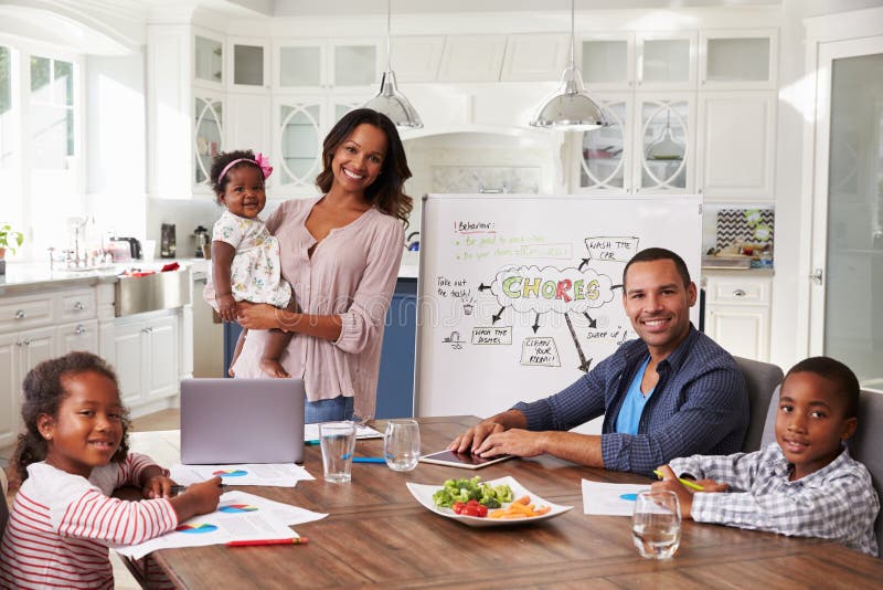 Domestic meeting in the kitchen, family looking to camera stock image Domestic meeting in the kitchen, family looking to camera stock image