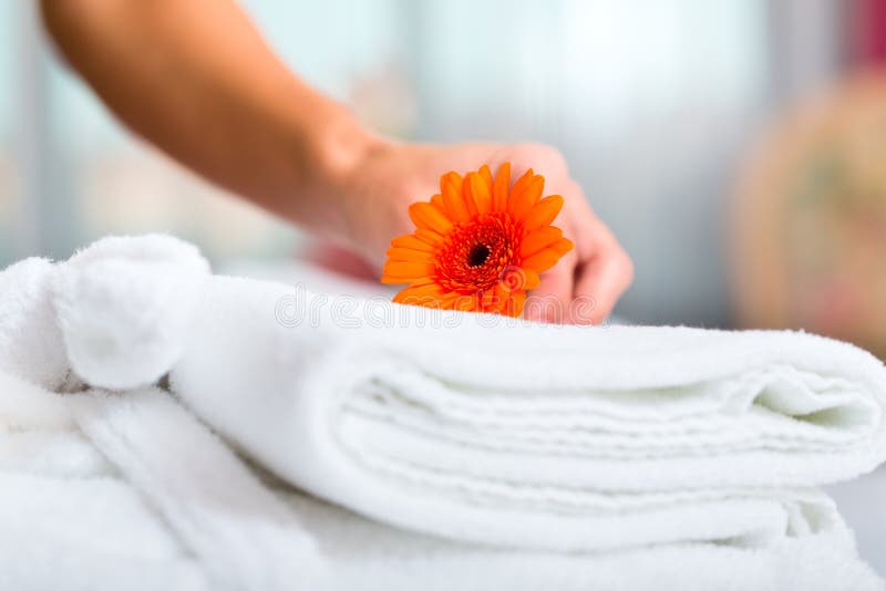 Maid doing room service in hotel, she is making up the beds. Maid doing room service in hotel, she is making up the beds