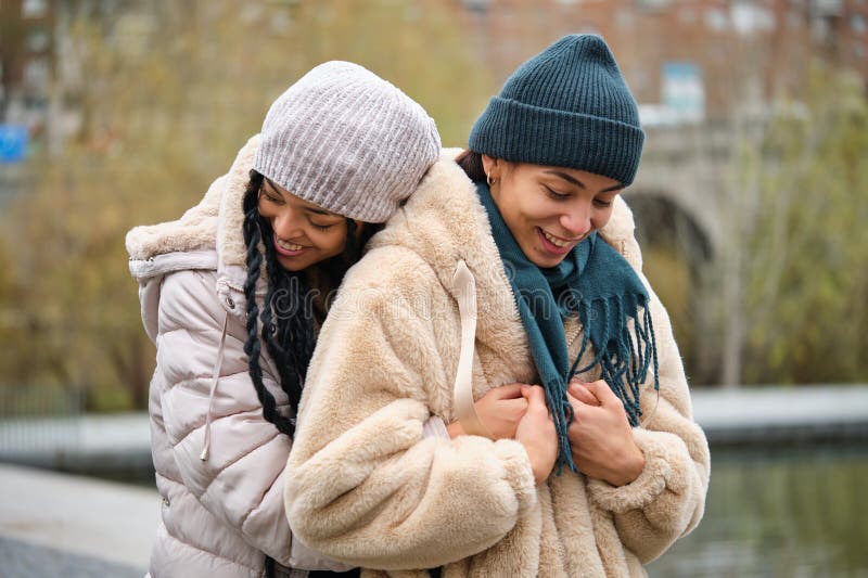 Dominican Lesbian Couple Hugging With Affection And Love At Street In Winter Stock Image