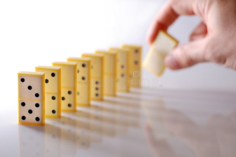 Hand setting up domino block