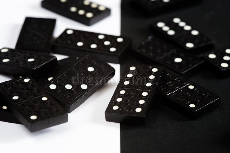 Black Dominoes game block in a row on a colored background Stock Photo -  Alamy