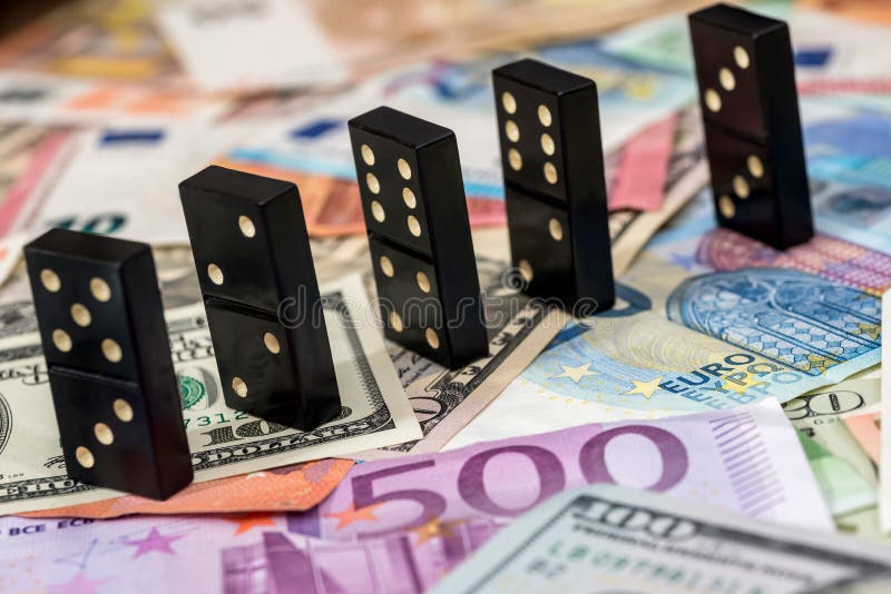 Dominoes on euro and dollar stock photos Dominoes on euro and dollar stock photos