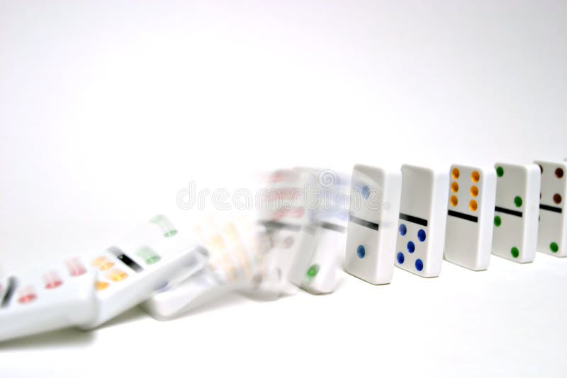 Dominoes falling on white