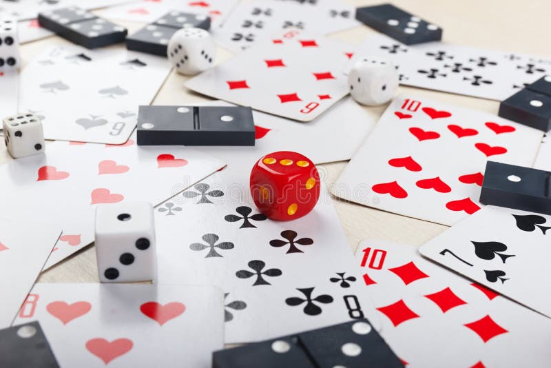 Playing Cards, Dominoes and Dice for Board Games on Table Close Up