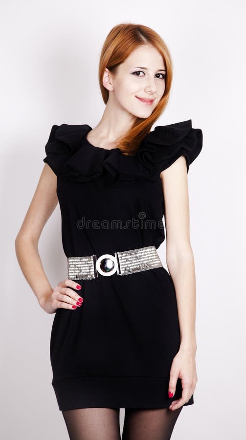 Domnișoară roșcată tânără în rochie neagră, care se prezintă stock image