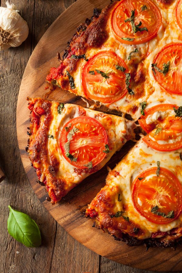 Homemade Vegan Cauliflower Crust Pizza with Tomato and Basil. Homemade Vegan Cauliflower Crust Pizza with Tomato and Basil