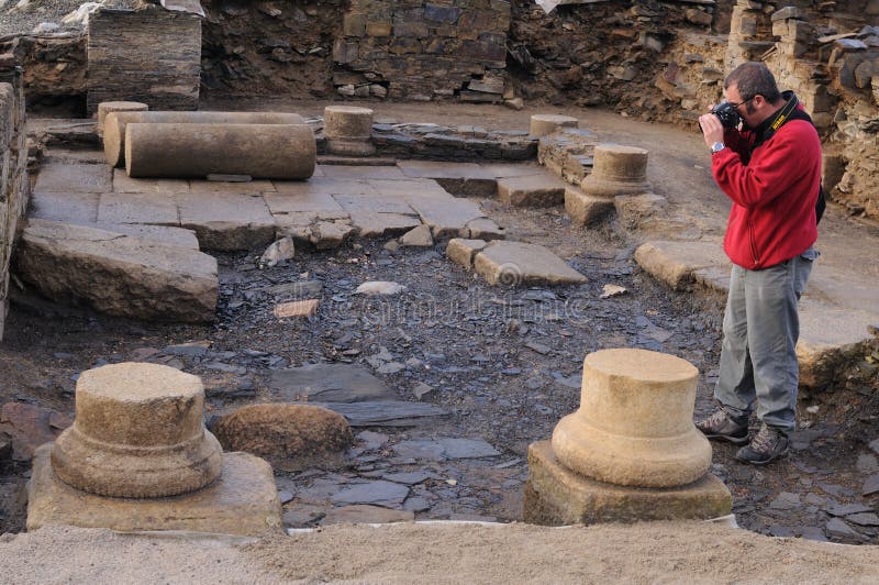 Archaeologist taking photos in the patio of the Domus Archaeological site Chao Samartin Asturias SPAIN. Archaeologist taking photos in the patio of the Domus Archaeological site Chao Samartin Asturias SPAIN