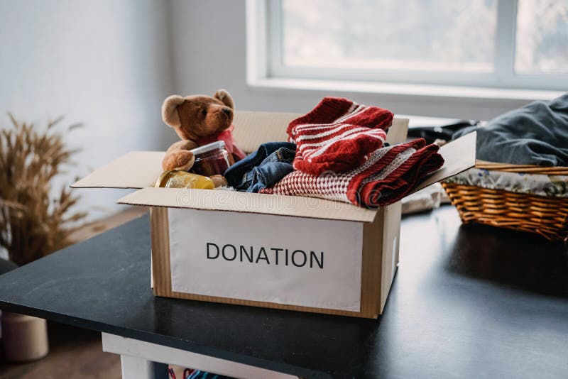 Donation box, Charity Gift hampers, Help Refugees and homeless. Christmas Xmas Charity Donation box with warm clothes, food and toys at home. Charities giving winter hampers to families in need. Donation box, Charity Gift hampers, Help Refugees and homeless. Christmas Xmas Charity Donation box with warm clothes, food and toys at home. Charities giving winter hampers to families in need.