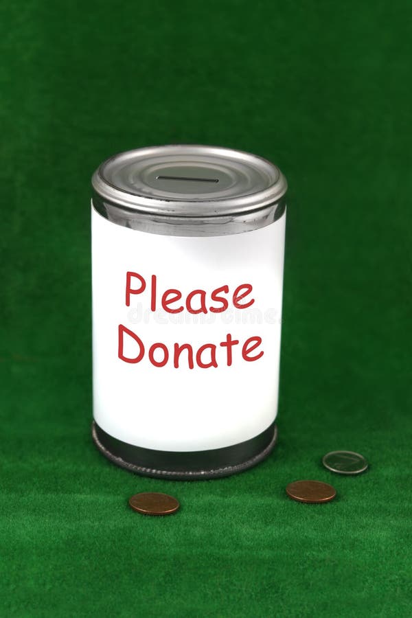 Change laying beside a donation charity tin can. Change laying beside a donation charity tin can