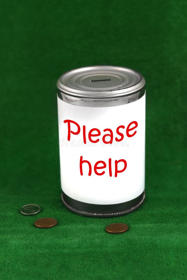 Change laying beside a donation charity tin can with the saying ' please help'. Change laying beside a donation charity tin can with the saying ' please help'