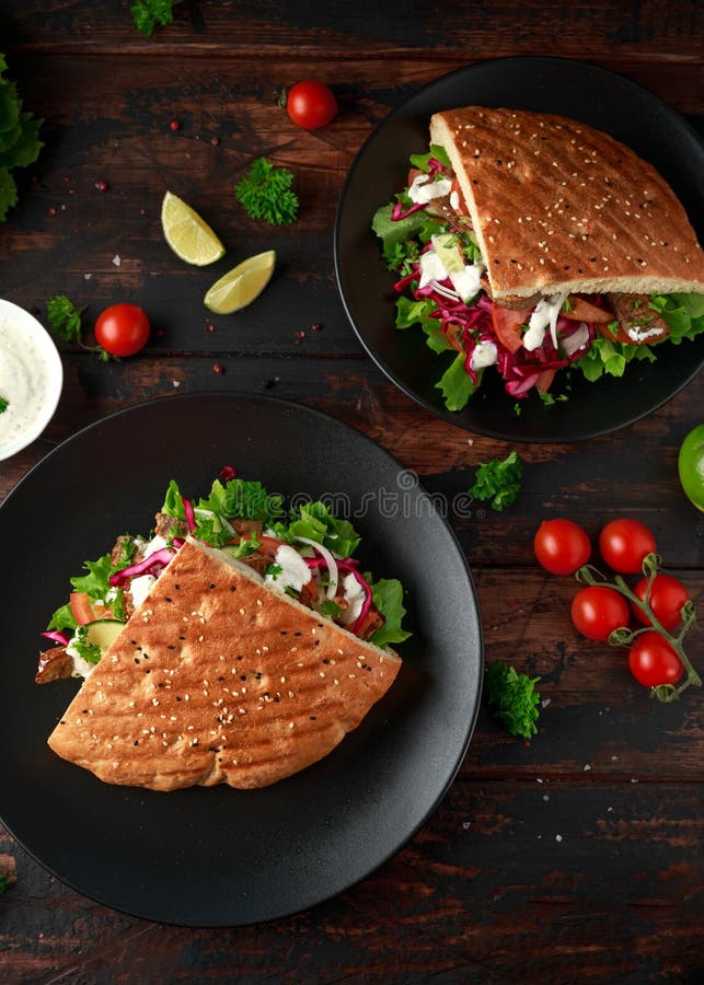 Doner kebab, fried lamb meat with vegetables and garlic sauce in turkish bread