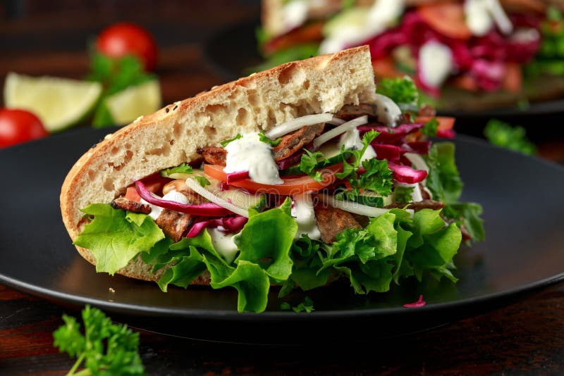 Doner Kebab, Fried Lamb Meat with Vegetables and Garlic Sauce in