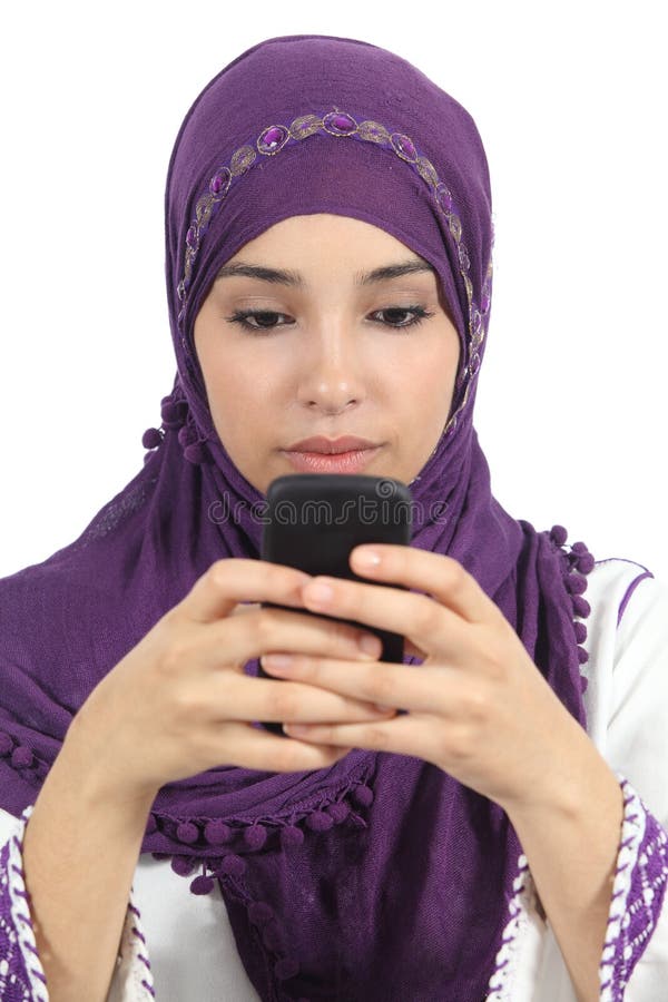 Arab woman writing a message addicted to the smart phone isolated in a white background. Arab woman writing a message addicted to the smart phone isolated in a white background