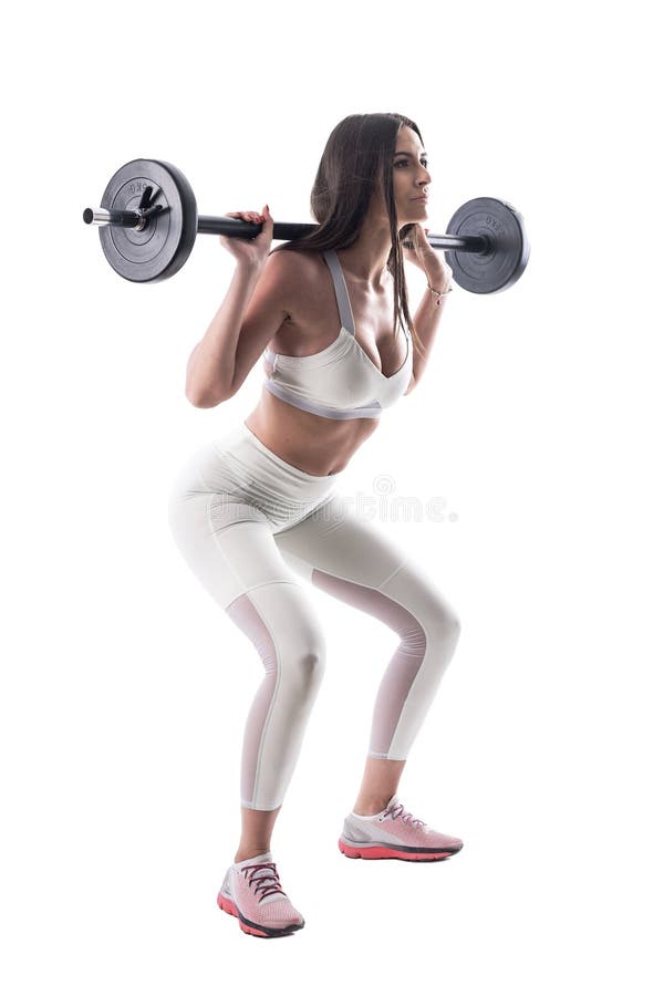 Donna attraente di forma fisica sicura motivata che fa gli esercizi tozzi della palestra con il bilanciere immagini stock libere da diritti Donna attraente di forma fisica sicura motivata che fa gli esercizi tozzi della palestra con il bilanciere immagini stock libere da diritti