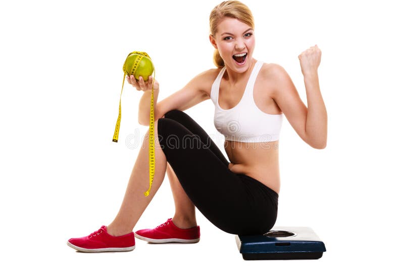 Woman sitting on weighing scale, holding grapefruit and measurement tape clenching her fist. Successful diet dieting slimming. Healthy lifestyle and body care concept. Woman sitting on weighing scale, holding grapefruit and measurement tape clenching her fist. Successful diet dieting slimming. Healthy lifestyle and body care concept.