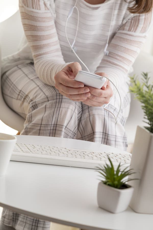 Detail of female hands holding a smart phone, surfing the net and scrolling. Detail of female hands holding a smart phone, surfing the net and scrolling.