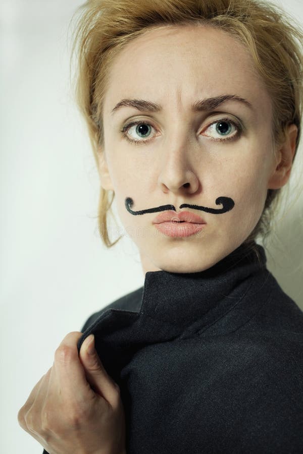 Beautiful young woman with painted mustache wearing jacket. Beautiful young woman with painted mustache wearing jacket