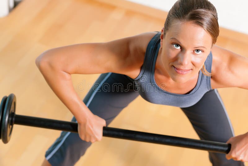 Donna con il barbell in ginnastica