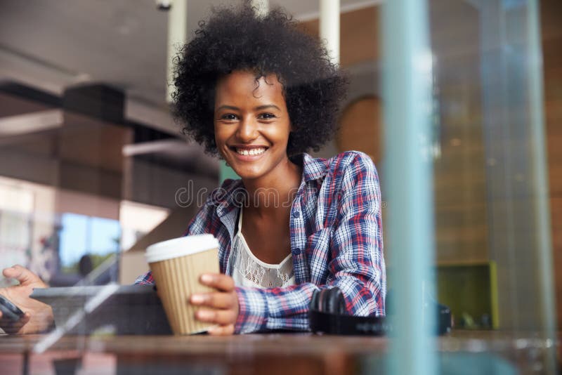 Smiling Businesswoman Using Digital Tablet In Coffee Shop. Smiling Businesswoman Using Digital Tablet In Coffee Shop