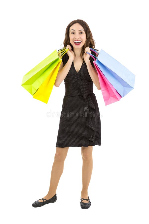 Donna di Shopaholic felice e che porta emozionante i sacchetti della spesa fotografia stock Donna di Shopaholic felice e che porta emozionante i sacchetti della spesa fotografia stock