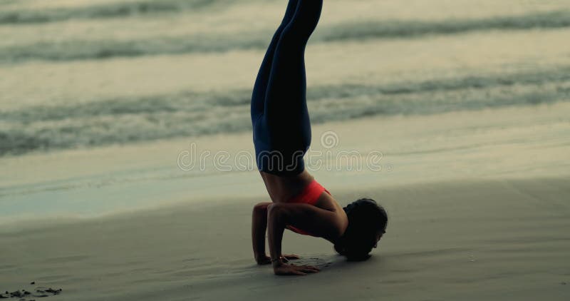 Silhouette woman doing yoga pose on mat outdoor stretching relaxation exercise fitness sport for healthy on the beach and seaside at sunset relax holiday vacation time in summer. Silhouette woman doing yoga pose on mat outdoor stretching relaxation exercise fitness sport for healthy on the beach and seaside at sunset relax holiday vacation time in summer