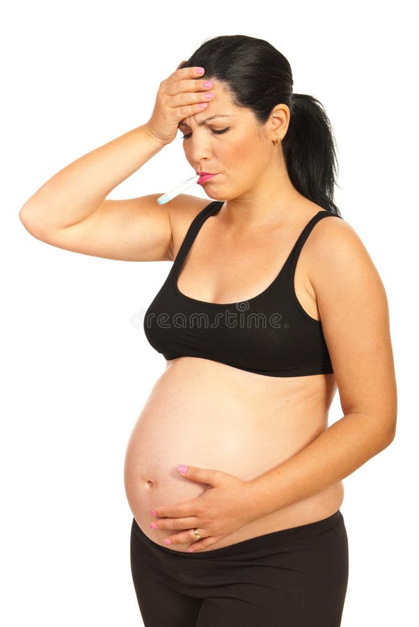 Donna incinta che ha febbre immagine stock libera da diritti Donna incinta che ha febbre immagine stock libera da diritti