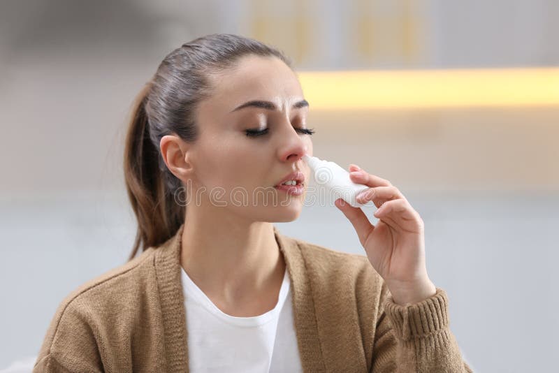 Ill woman using nasal spray. Ill woman using nasal spray