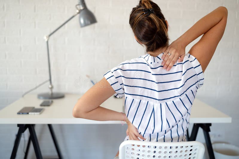 Overworked woman with back pain in office sitting on chair with bad posture. Overworked woman with back pain in office sitting on chair with bad posture