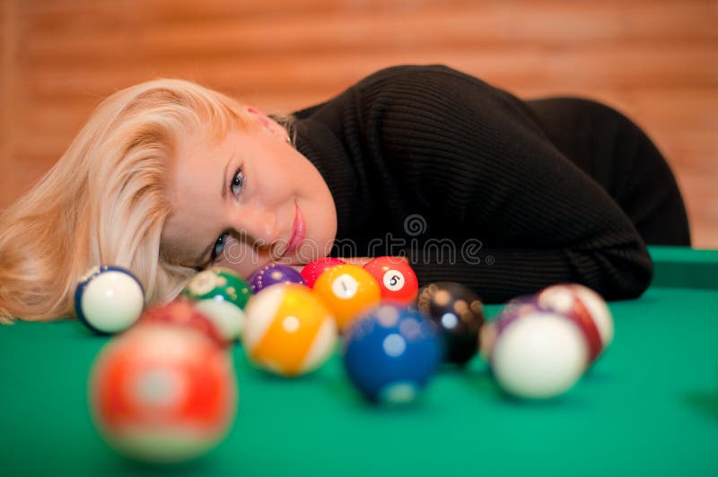 woman with billiard balls on green table. woman with billiard balls on green table