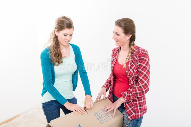 Donne che imballano la scatola di cartone immagine stock Donne che imballano la scatola di cartone immagine stock
