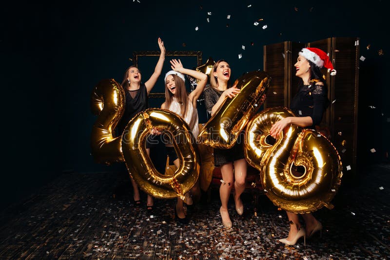 Happy Women in Santa hats celebrate New year. Happy Women in Santa hats celebrate New year