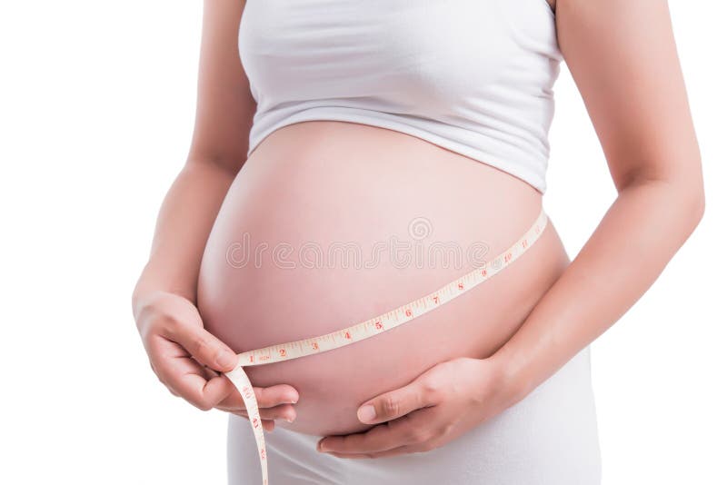 donne incinte una pancia di misurazione da 9 mesi in un fondo bianco fotografie stock donne incinte una pancia di misurazione da 9 mesi in un fondo bianco fotografie stock