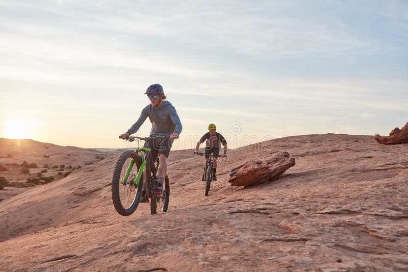 Dont limit your challenges, challenge your limits. Full length shot of two young male athletes mountain biking in the