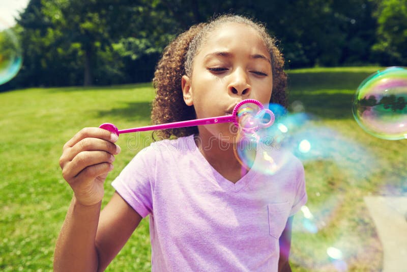 Dont Pop My Bubbles. a Little Girl Blowing Bubbles Outdoors. Stock