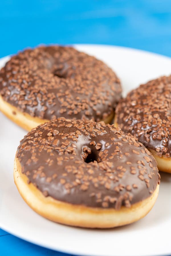 Donut with Chocolate Topping Cream on the Blue Background Stock Image