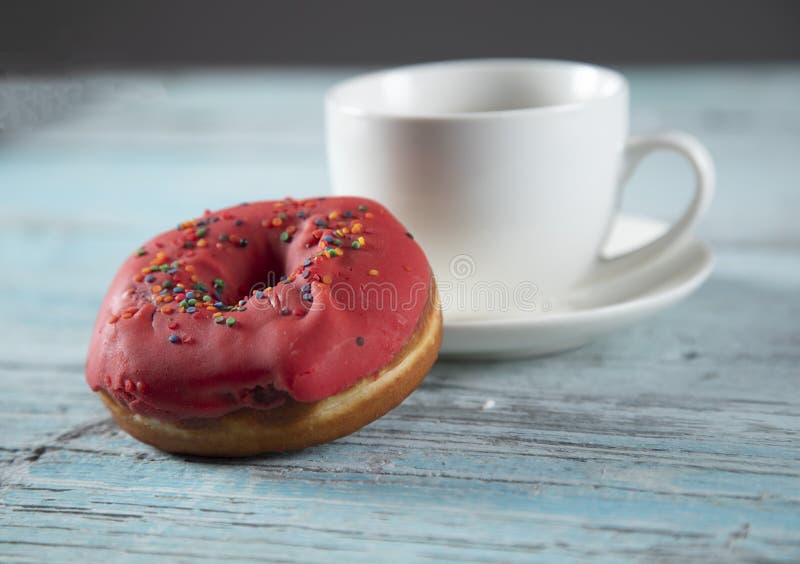 Donut and coffee on table stock image. Image of doughnut 186696899