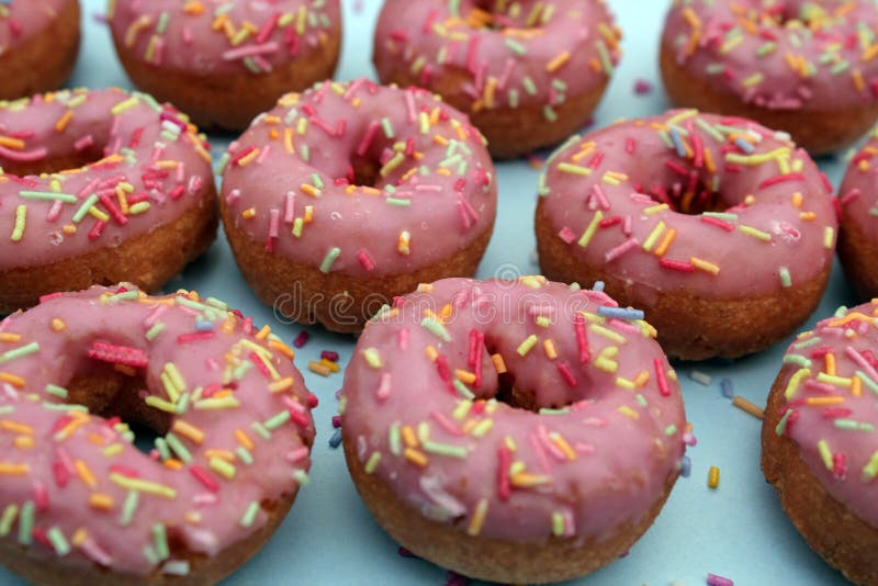 Donuts with Sprinkles on Pink Background. Sugar, Calories, Homemade