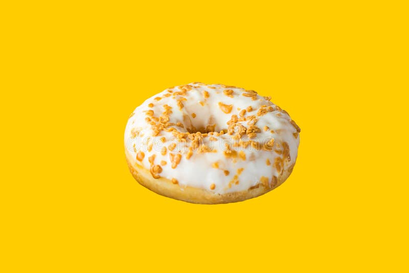 Donut glazed with white icing caramel sprinkles floating in air on yellow background. Creative food poster for sweet pastry