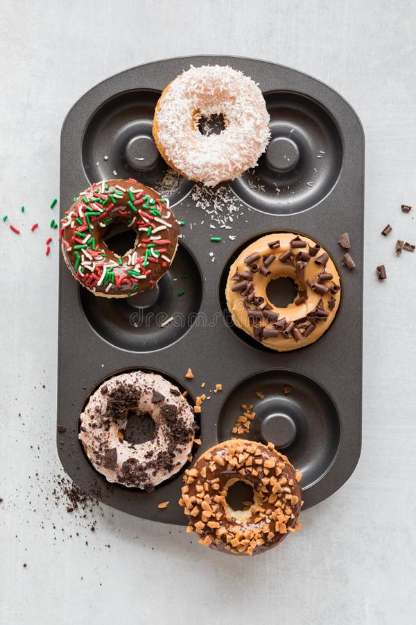 A Donut Pan Topped with Various Homemade Donuts with Different Toppings