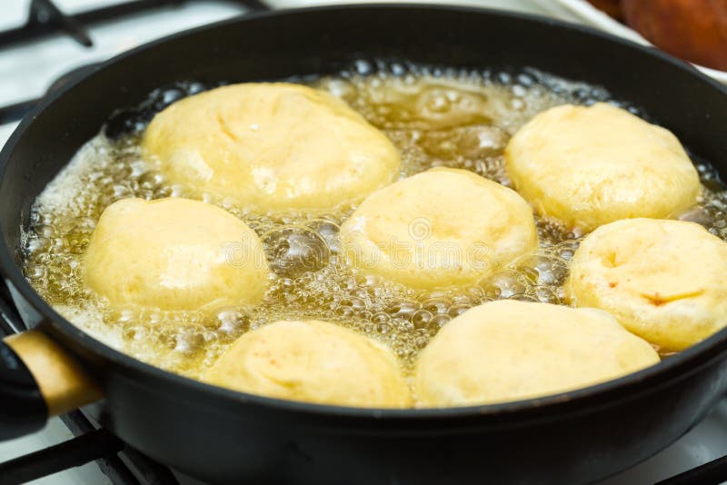 Donuts frying in deep fat stock image. Image of dish 81624947