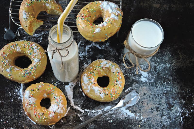 Donuts with Powdered Sugar and Milk. Fresh Colored Soft Donuts Stock