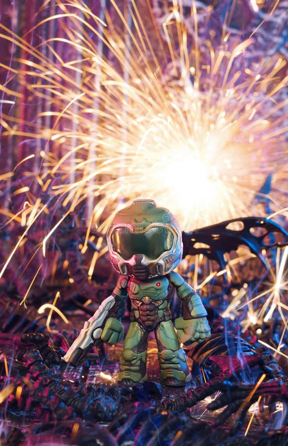 MAGNITOGORSK, RUSSIA - February 18, 2019: a single Doomguy figurine, which represents a protoganist from the computer games series `Doom `. The explosion effect is real and created using sparklers. Illustrative editorial.