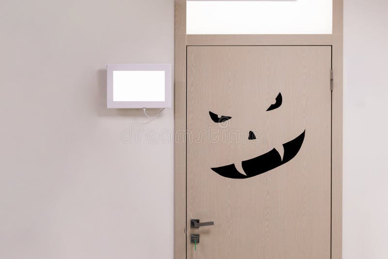 Wooden door with black angry scary monster face. Concept of doctor or medicine phobia or fear .