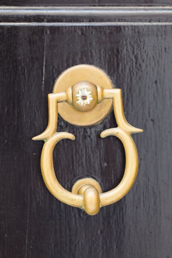 Decorative Maltese Door Knob on Brown Doors Stock Image Image of
