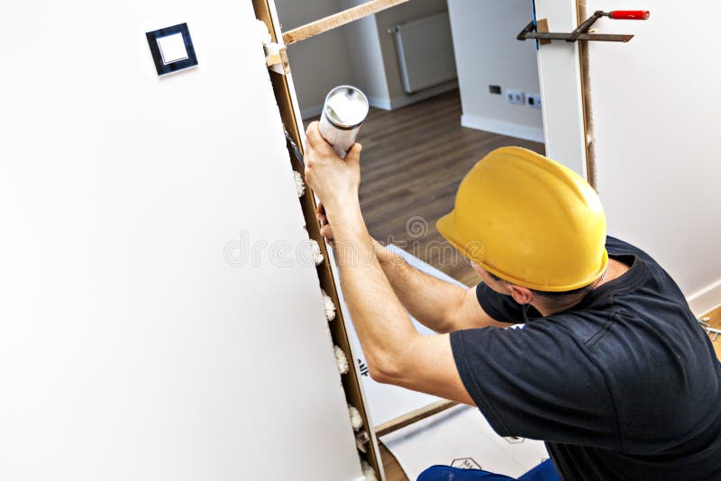 Door Installation. Carpenter Installing Doors Stock Photo Image of
