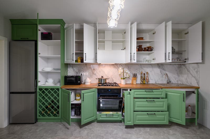 Doors Open and Drawers Pulled Out at New Green and White Kitchen Furniture Stock Photo Image